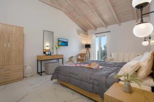 a bedroom with a large bed and a desk at Kouros Hill in Xirokástellon