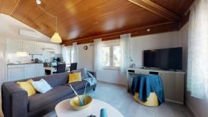 a living room with a couch and a kitchen at LORA apartment with beautiful sea & park view in Novigrad Istria