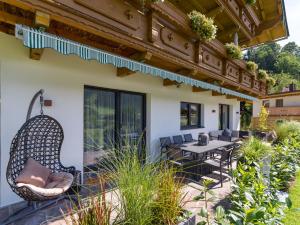 an outdoor patio with chairs and a table at Appartements Retthäusl in Going