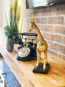 a statue of a giraffe next to a telephone at habitat The River Apartment in Ruse