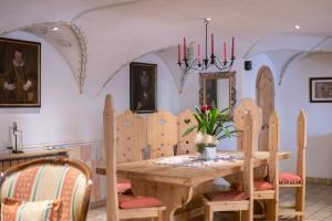 a dining room with a wooden table and chairs at Appartments Peter in Colfosco