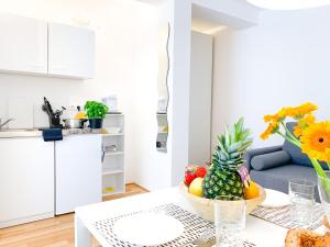 a kitchen with a table with a bowl of fruit at Relax Aachener Boardinghouse Appartements Premium 1 in Aachen