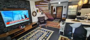 a living room with a flat screen tv on a wall at Traumvilla in Kusadasi in Kusadası