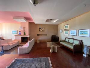 a living room with a couch and a fireplace at Vista Mare a 300 mt dalla spiaggia in Cariati