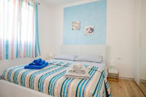 a bedroom with a bed with towels on it at Exclusive Seaside Dream Apartments in Murter