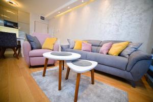 a living room with a couch and two tables at Apartment Center Valley in Vila Pekovic Green in Zlatibor