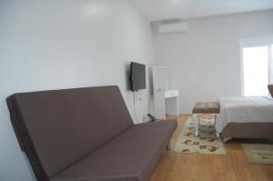 a bedroom with a bed and a tv on the wall at RI-VAL in Valandovo