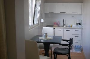 a small kitchen with a black table and chairs at RI-VAL in Valandovo