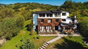 an aerial view of a house on a hill at Talhaus in Vişeu de Sus