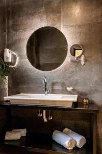 a bathroom with a sink and a mirror at Hotel Park in Larisa