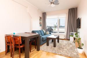 a living room with a table and a couch at Tallinn Center Jõe Apartment in Tallinn