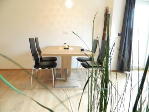 a dining room table with two chairs and a bowl on it at Haus 4 Holidays in Bramberg am Wildkogel
