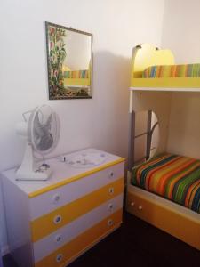 a bedroom with a dresser and a bunk bed at Casa San Salvatore in Càbras