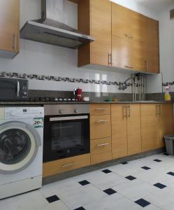 a kitchen with a washing machine and a washer at Living Pontevedra in Pontevedra