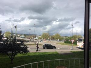 a person crossing a street with a car in a parking lot at Living Pontevedra in Pontevedra