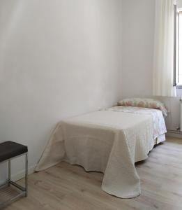 a bedroom with a bed with a blanket on it at Living Pontevedra in Pontevedra +8 photos