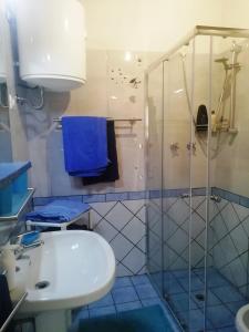 a bathroom with a shower and a sink and a toilet at Casa San Salvatore in Càbras