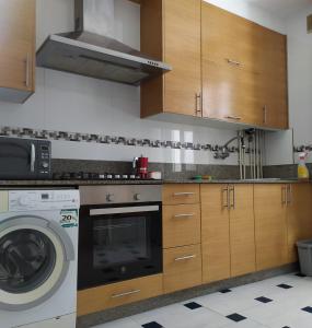 a kitchen with a washing machine and a washer at Living Pontevedra in Pontevedra