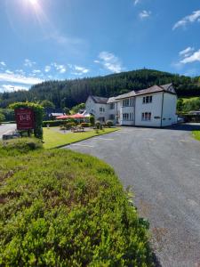 a large white building with a sign in front of it at Glenwood Guesthouse Betws-y-coed in Betws-y-coed
