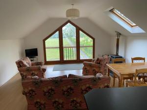 a living room with a couch and a table at The Loft in Kilmessan