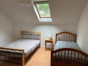 a bedroom with two beds and a window at The Loft in Kilmessan
