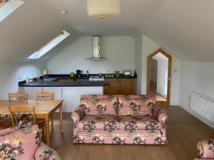 a living room with a couch and a table at The Loft in Kilmessan