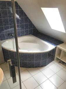 a bath tub in a bathroom with blue tiles at Chalet Étoile des neiges in Barèges +17 photos