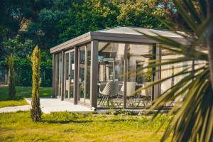 a gazebo with a chair in a garden at Prea Gianca in Bonifacio