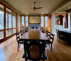 une salle à manger avec une table, des chaises et une cheminée dans l'établissement Atulya Villas Nuwara Eliya, à Nuwara Eliya