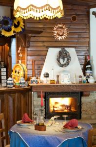 a dining room with a table with a fireplace at Hotel Palavas in Villar Pellice