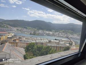 a view of a city and a river from a window at Ático con maravillosas vistas in Viveiro
