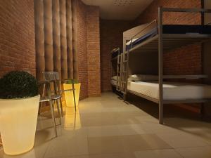 a room with bunk beds and a brick wall at albergue SANTO SANTIAGO in Santiago de Compostela