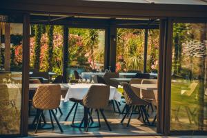 a restaurant with tables and chairs and windows at Prea Gianca in Bonifacio
