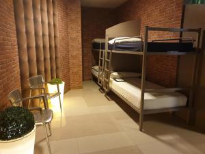 a room with bunk beds in a brick wall at albergue SANTO SANTIAGO in Santiago de Compostela