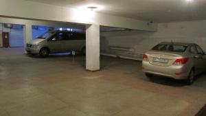 two cars are parked in a parking garage at Optima Collection Gallery Poltava in Poltava