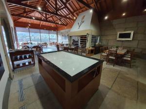 a large room with a pool table in a restaurant at Hotel Rural Casa de Samaioes in Chaves