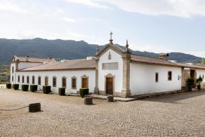 a white building with a cross on top of it at Hotel Rural Casa de Samaioes in Chaves