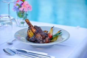 a plate of food on a table with a plate of food at Prea Gianca in Bonifacio