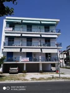 a hotel with a car parked in front of it at To Giouli in Volos