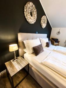 a bedroom with a bed and two mirrors on the wall at Boutique Apartment Anne in Bad Harzburg