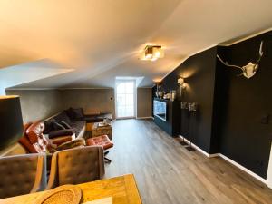 a living room with a couch and a table at Boutique Apartment Anne in Bad Harzburg