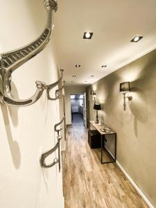 a hallway with a vanity and a wall with a light fixture at Boutique Apartment Anne in Bad Harzburg