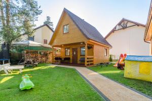 una casa con patio y parque infantil en Aurum domki, en Jarosławiec
