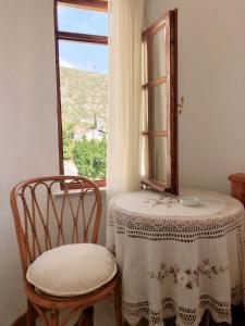 a table and two chairs in front of a window at Kekova Hotel in Kaş