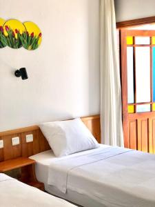 a bedroom with two beds and a window at Kekova Hotel in Kaş