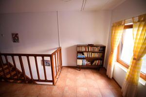 a room with a staircase and a book shelf at Vila toate Panzele Sus in Corbu