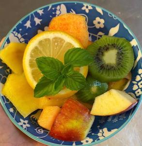 a blue and white bowl filled with fruits and vegetables at Agriturismo Rossococomero in Sirolo