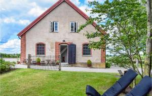 a brick house with a blue door at Nice Home In Hammenhg With House A Panoramic View in Hammenhög