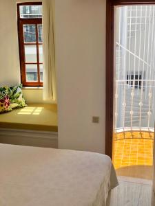 a bedroom with a bed and a window at Kekova Hotel in Kaş