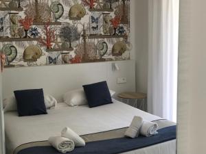 a bedroom with a bed with blue and white pillows at Prea Gianca in Bonifacio